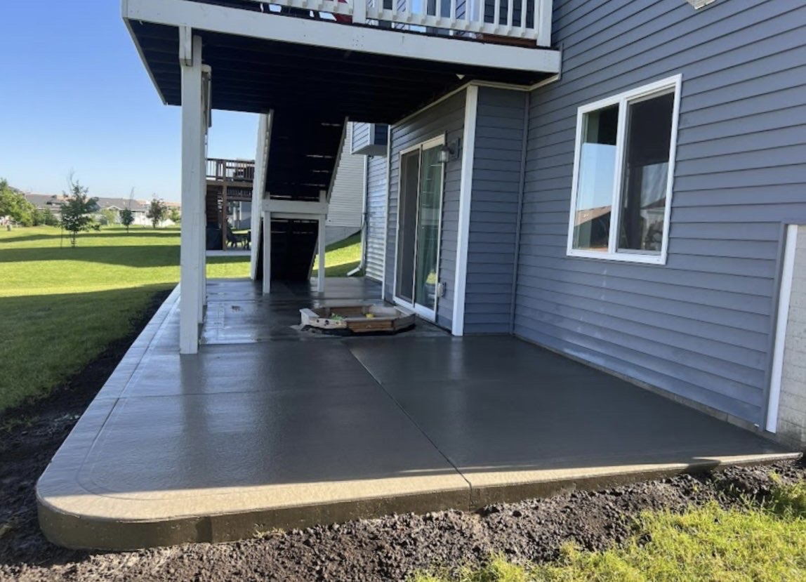Concrete patio under deck with smooth finish