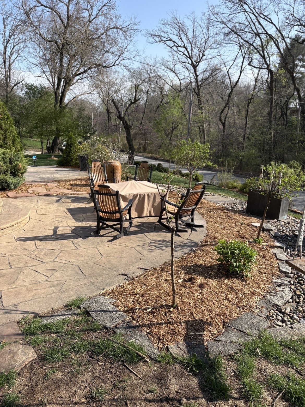 Custom flagstone patio and outdoor living seating area with rocking chairs in Des Moines