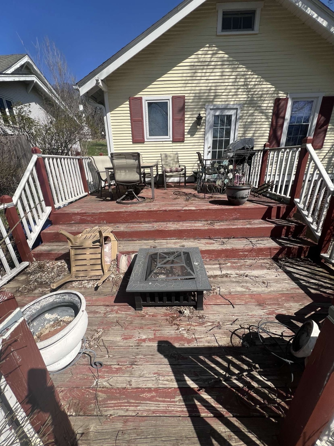 Deck before staining showing worn peeling paint in Des Moines