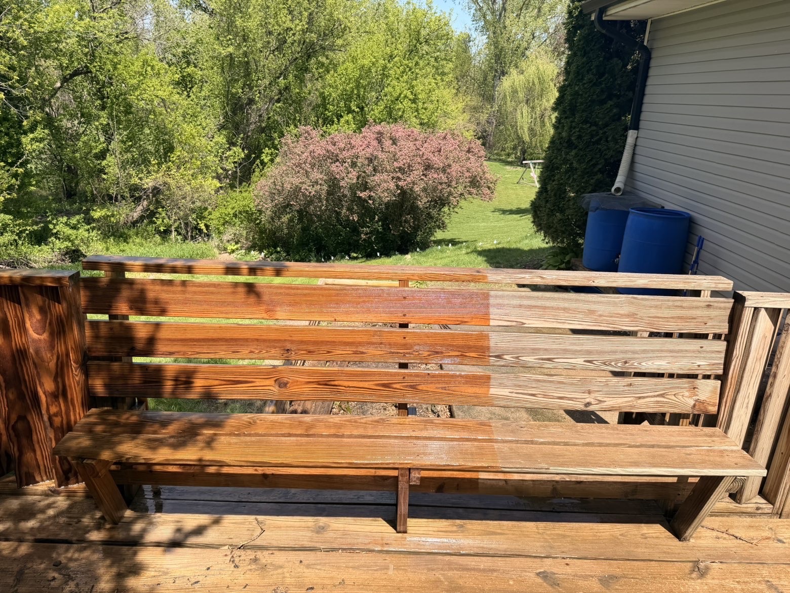 Deck bench before and after professional staining showing rich color restoration in Des Moines