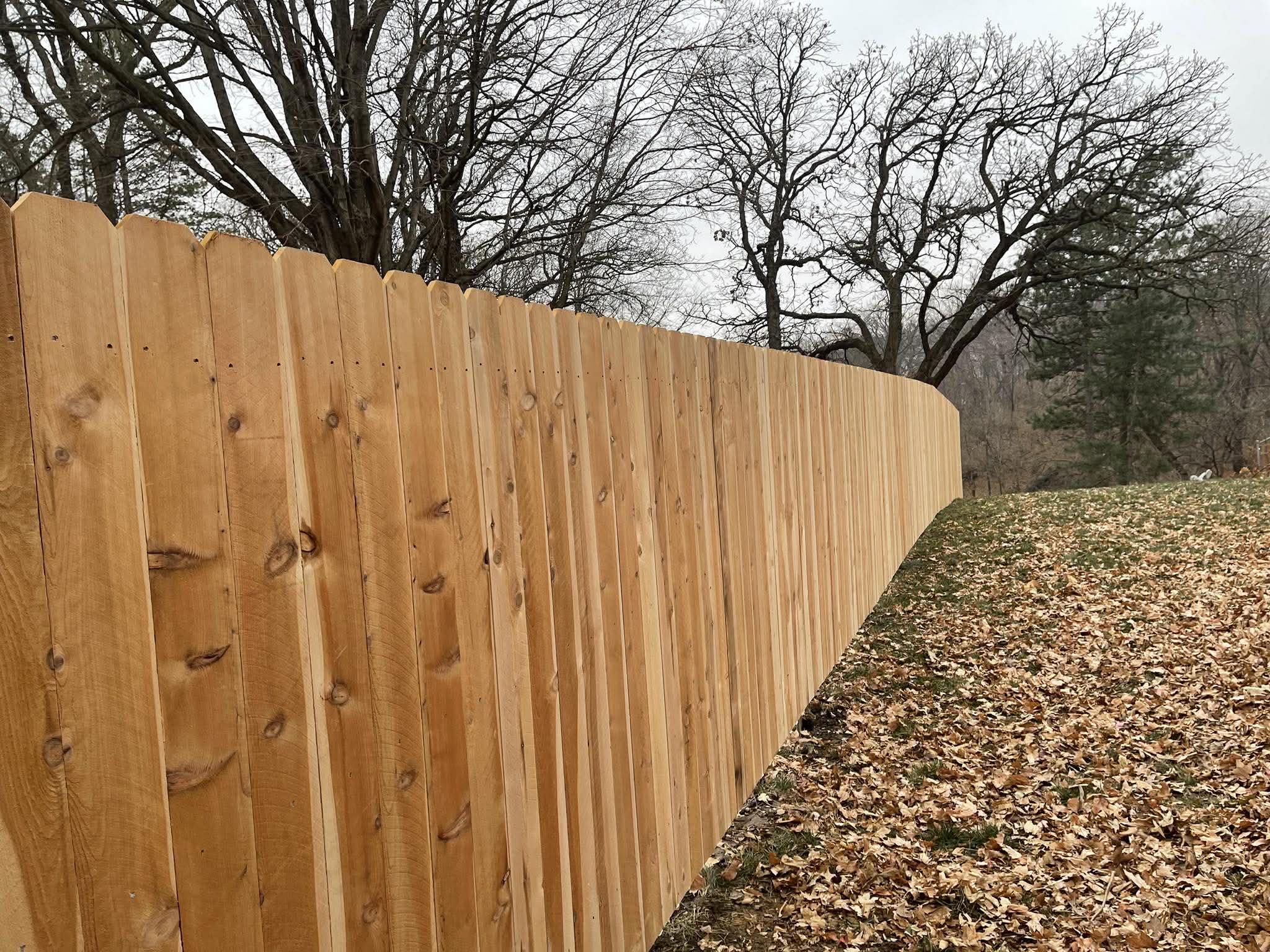 Cedar wood privacy fence along property line in Des Moines
