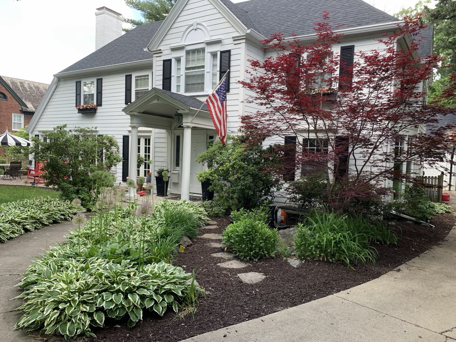 Professional flower bed design with hostas and mulch in Des Moines