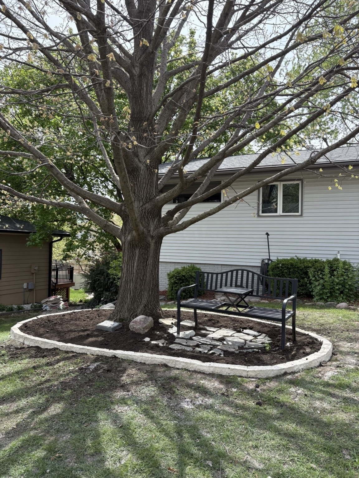 Landscaping with flagstone seating pad and stone border in Des Moines