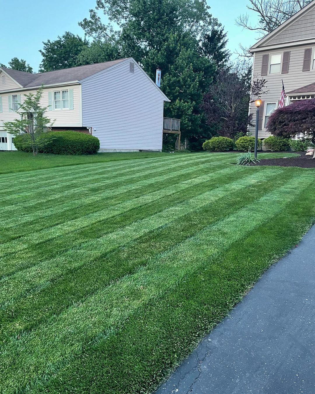 Professionally striped lawn mowing in Des Moines neighborhood