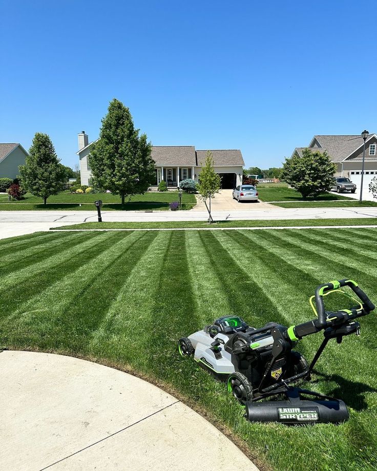 Fresh lawn mowing with professional striping and equipment