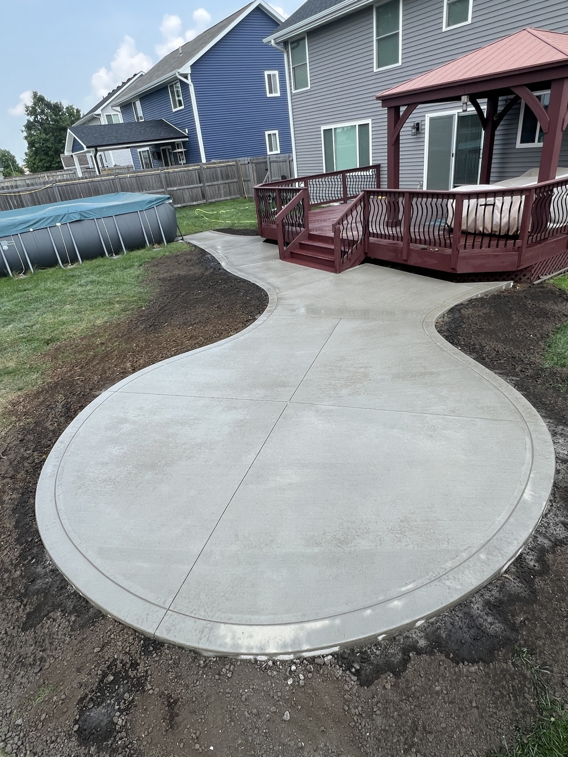 Curved concrete patio and walkway leading to gazebo in Des Moines