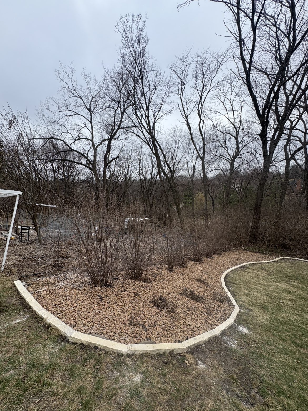 Curved stone border with rock fill landscaping in Des Moines backyard