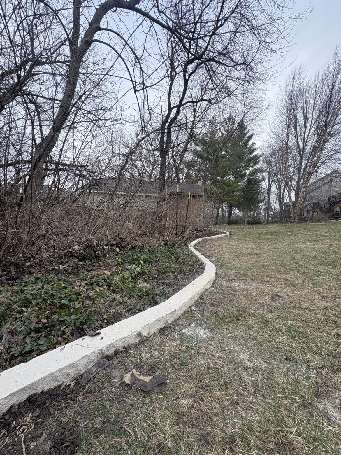 Winding stone border along property edge in Des Moines