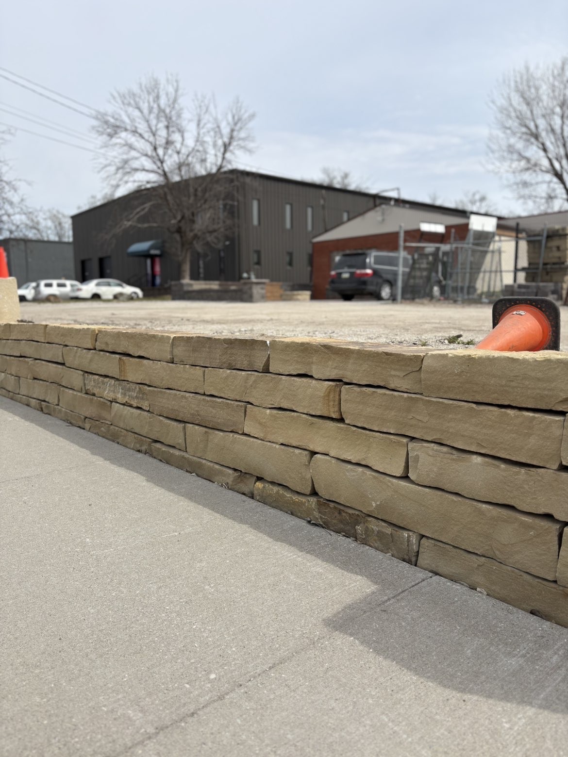 Natural stone retaining wall along commercial property