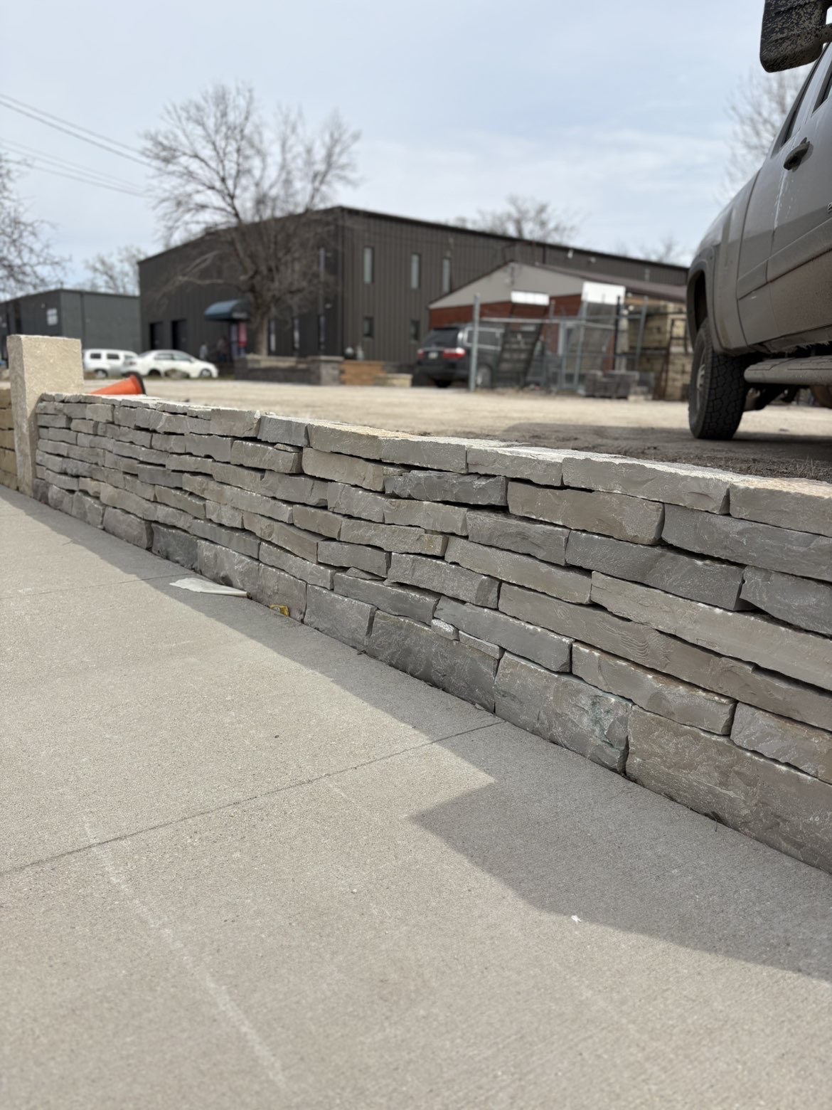 Grey stacked stone retaining wall at business location